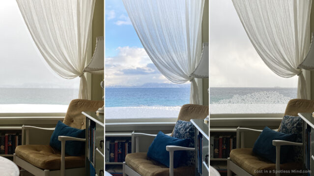 Three side-by-side photos, showing the same interior scene of a 50s armchair with velvet cushions, a low bookshelf, and a sweeping transparent curtain in front of a window. The ocean view outside differs between grey and grim, blue and bright, and white and wintery.