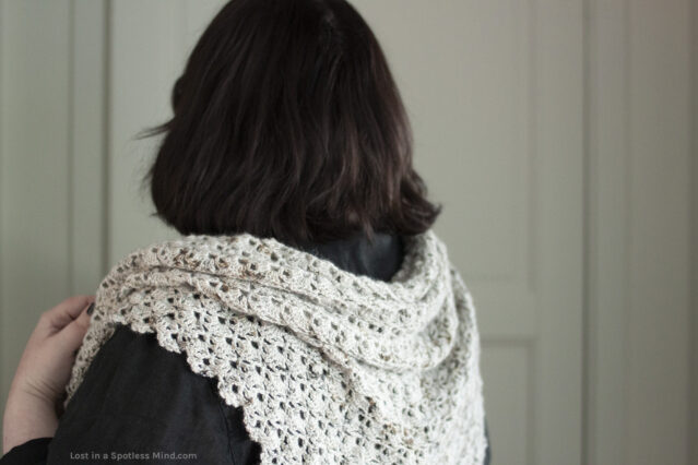 Me wearing a lacy crochet shawl, face turned away from the camera.